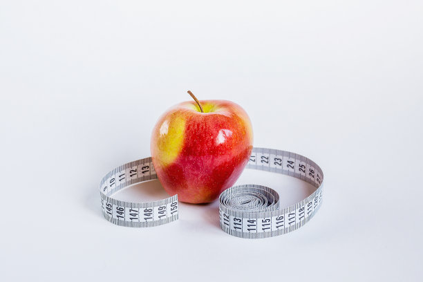 饮食、健康饮食、饮食与减肥的概念。苹果旁边的卷尺。图片下载