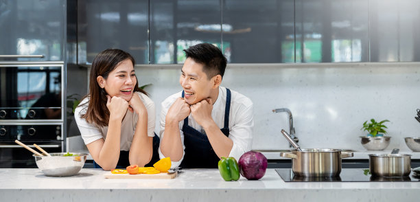 微笑亚洲夫妇在厨房用锅和平底锅做饭的画像。快乐亚洲家庭与爸爸妈妈，familyâ ' '的节日，一起保健烹饪植物为主的饮食食品概念图片下载
