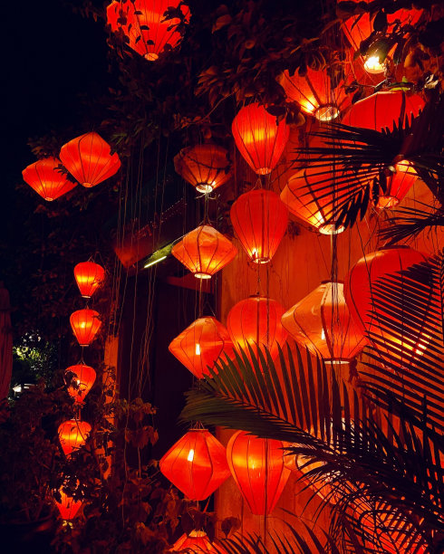 垂直拍摄的美丽的发光的橙色纸灯笼在晚上图片下载