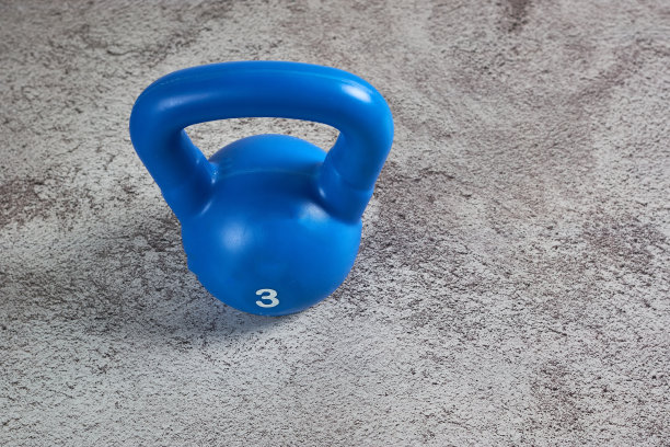 蓝色3公斤铸铁重量在灰色柔软的地毯表面图片下载