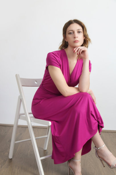 系列工作室照片的年轻女模特在亮粉色裹裙。图片下载