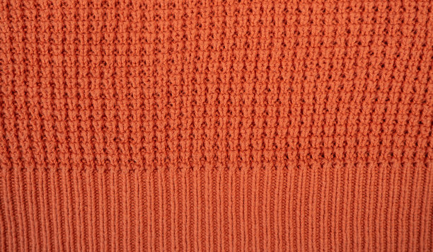 羊毛针织衫的质地。天然羊绒面料，羊毛衫碎片。针织图案特写。图片下载
