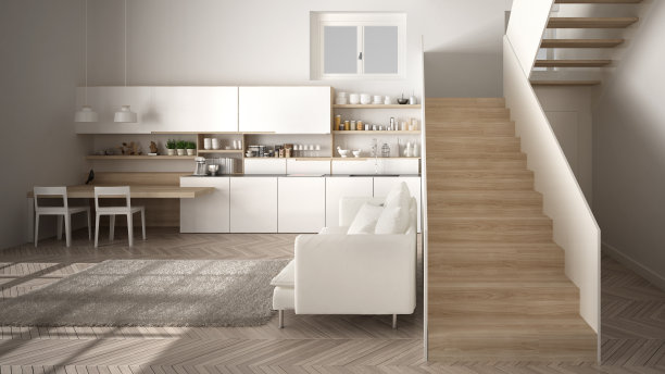 极简主义的现代白色和木制厨房在现代开放空间与干净的楼梯，客厅与沙发和地毯，室内设计的建筑概念理念图片下载