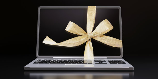 黑色星期五，网络星期一大减价。金色礼品缎带蝴蝶结电脑笔记本电脑图片下载