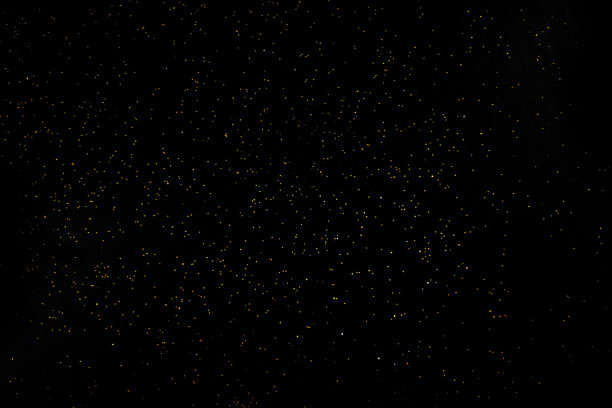 深色的质地中有金色的点缀。背景与金色闪光覆盖照片效果滤镜。花哨，豪华，主题背景。图片下载