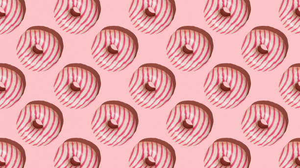 粉色背景上的粉色条纹甜甜圈图案。图片下载