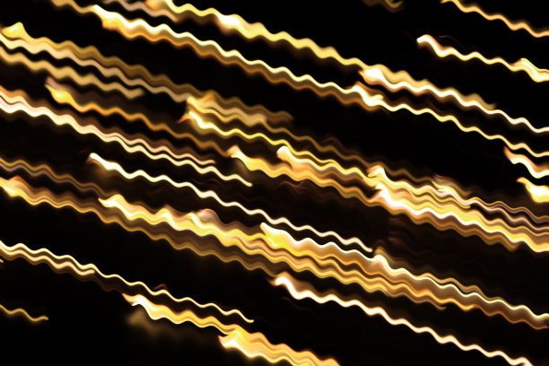 黄色发光漩涡波，火光效应，行，闪电放电。扭曲的黄色发光波浪曲线。技术，数据流在黑色隔离背景图片下载