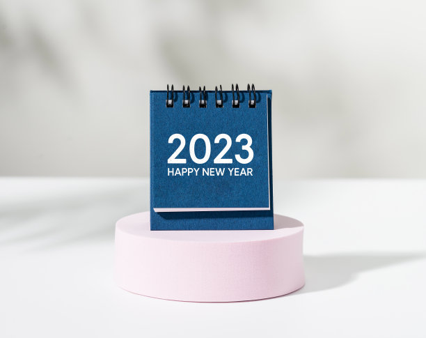 2023年新年快乐在白色背景的粉色讲台上。图片下载