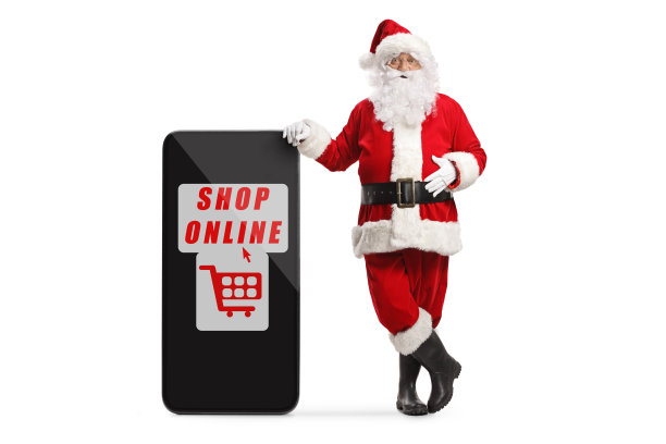 圣诞老人靠在手机上用文字在网上购物图片下载