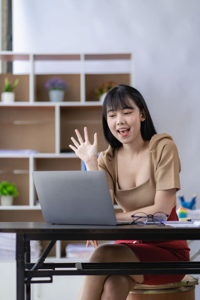 亚洲女商人在笔记本电脑上工作，年轻女子的财务文件喜气洋洋，在办公室的垂直图片中处理财务和计算器图片下载