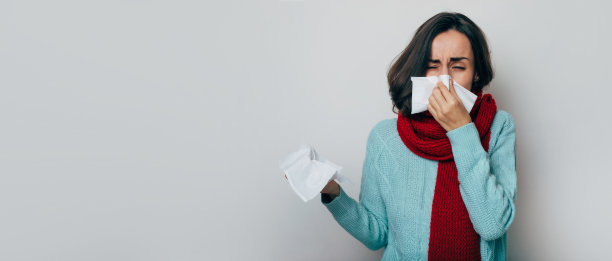 年轻女子发烧，裹着围巾咳嗽。患病女性患流感和头痛。鼻炎，感冒，疾病，过敏的概念。一阵咳嗽。冠状病毒流行图片下载