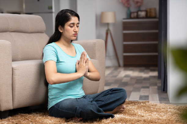 在家做瑜伽，女人做莲花式。库存图片图片下载