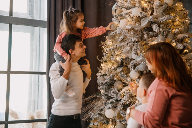 家里的妈妈，爸爸，弟弟和妹妹正在装饰圣诞树。图片下载