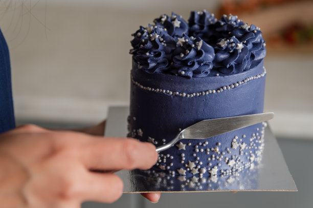 用抹刀把海绵蛋糕上的奶油抹平。图片下载