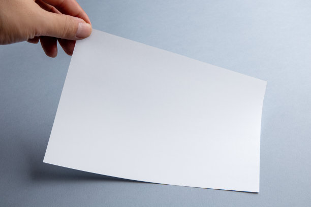 手握空白纸页，蓝色背景上有阴影图片下载