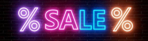 销售的概念。砖墙上的霓虹灯销售文字和百分比标志图片下载