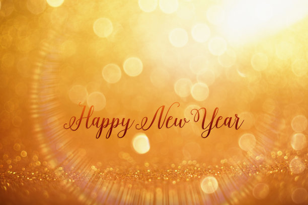 新年快乐的祝福在金色的散景球背景节日和新年的概念背景与闪烁明亮的散景圈图片下载