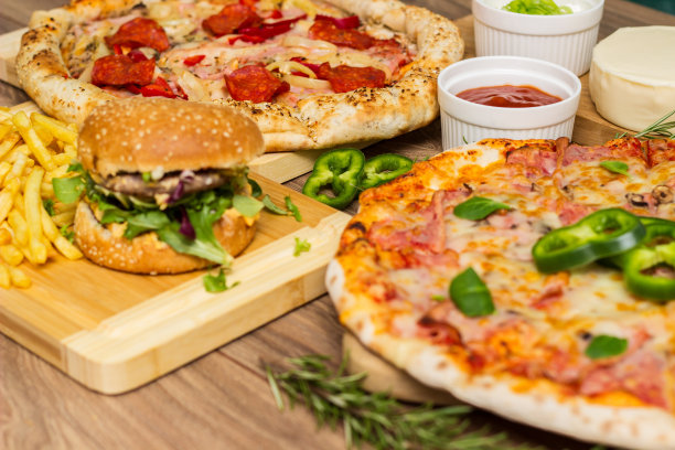 披萨和汉堡在木制背景上图片下载