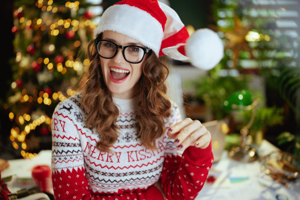 快乐的女老板在绿色的办公室和圣诞树图片下载