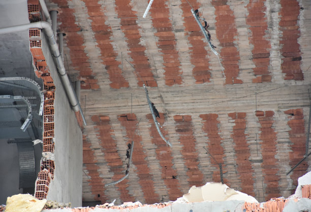 正在拆除的建筑物的砖墙和天花板，包括电、水和通风设施图片下载