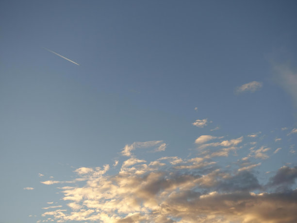 蓝色的天空上，飞机喷气发动机的烟尾图片下载