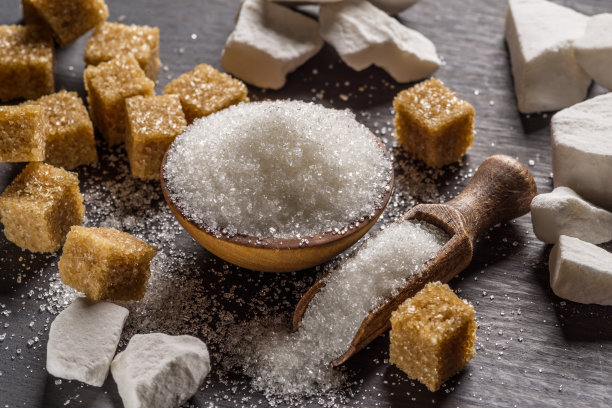 木碗里装砂糖，勺子里装砂糖，周围放方糖。图片下载