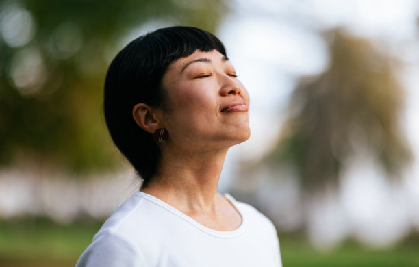 快乐的女人在城市公园里享受新鲜空气图片下载