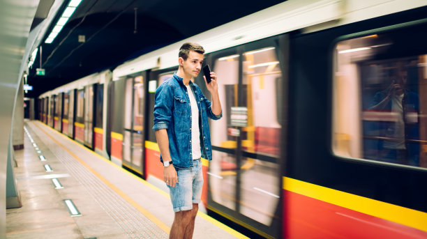 满足的年轻人在地铁里打电话图片下载