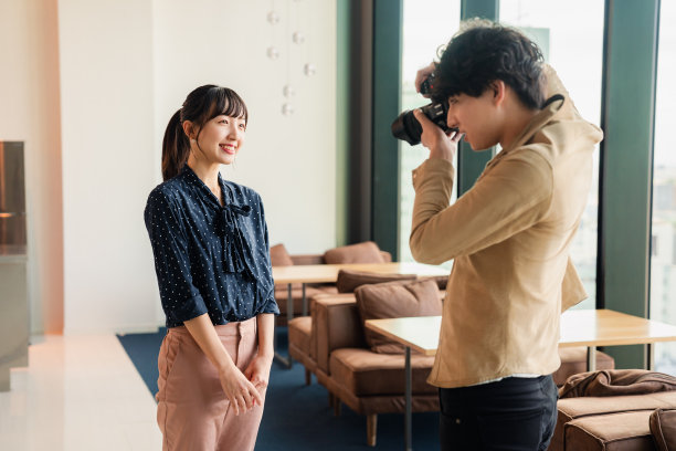 男性摄影师正在拍摄一名女性的肖像照片图片下载