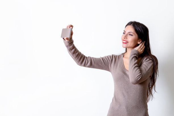 一名年轻女子用手机自拍图片下载