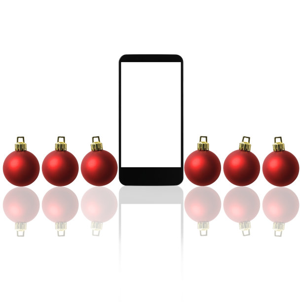 圣诞装饰品与白色背景的空白智能手机排列在一起图片下载