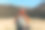 背影时尚的女人穿着绿色的背包和红色的帽子看着山景，在大自然中放松。旅行和漫游的概念。令人惊叹的寒意时刻图片下载