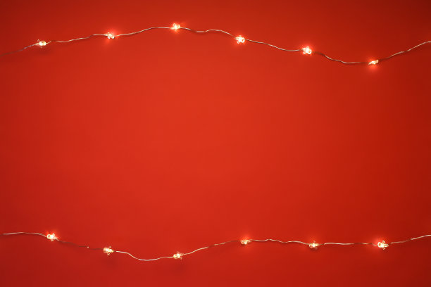 红色背景上的圣诞彩灯图片下载