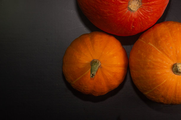 橘黄色的南瓜在黑色的背景上万圣节的概念和秋天收获的南瓜特写复制空间从上面图片下载