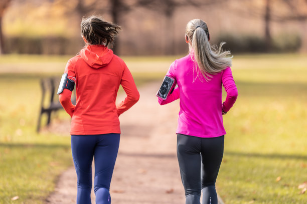 秋日公园里，两名女性跑步者的背影图片下载