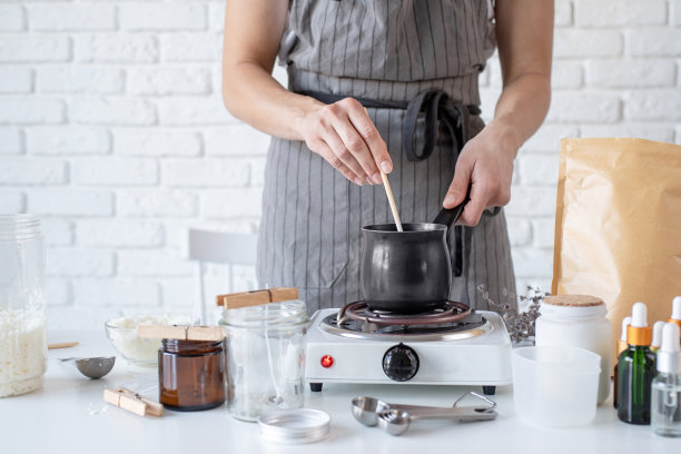 妇女在餐桌上制作装饰香薰蜡烛，特写图片下载