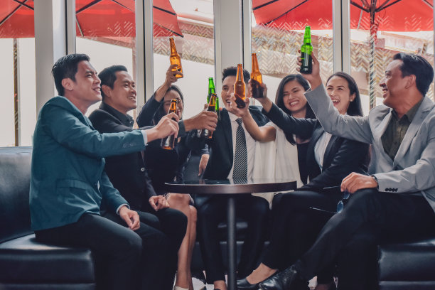 亚洲人在聚会上喝酒祝贺业务团队，一群朋友在酒吧享受晚上的饮料图片下载