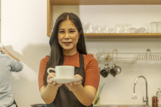 年轻的女咖啡店老板和她的服务图片下载