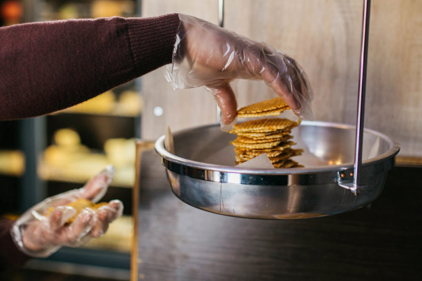 糖果师在餐厅厨房装饰糖果。糕点师正在制作手工作者蛋糕。烹饪食物的概念。图片下载