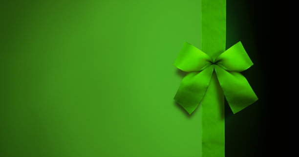 绿色的蝴蝶结与绿色的背景图片下载