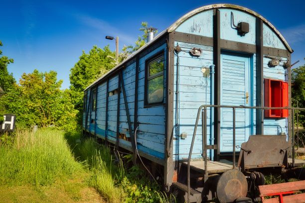 一个废弃车站的蓝色木制火车车厢特写图片下载