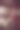 透过玻璃看到女子在公用电话亭拨打电话。图片下载