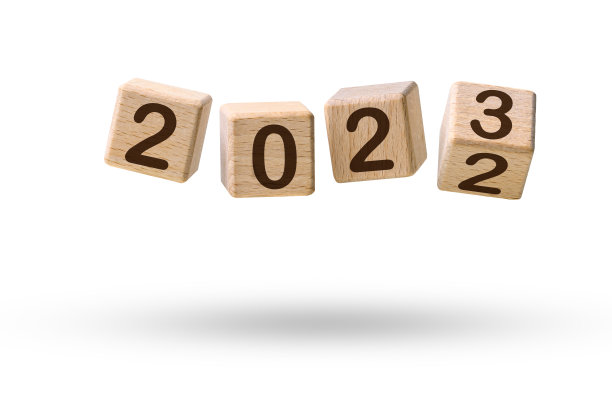 新年快乐的概念。从2022年到2023年的木制方块飞过白色图片下载