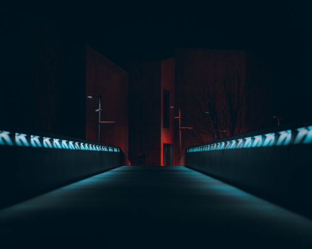 夜晚的城市景观，以现代建筑为背景的灯火通明的小巷图片下载