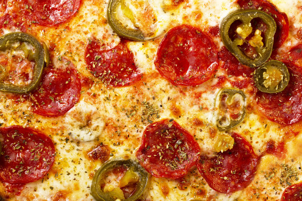 一个披萨的近景。宏观照片。意大利辣香肠香肠披萨配墨西哥胡椒。图片下载