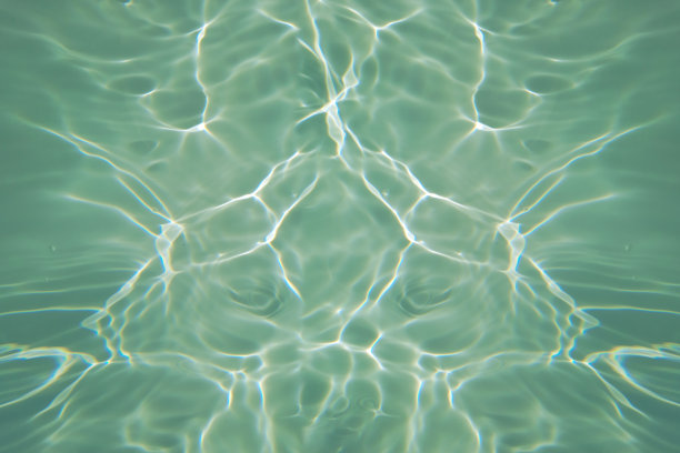 离焦模糊透明蓝色颜色清晰平静的水面纹理与飞溅和气泡。潮流抽象的自然背景。水波在阳光下复制空间。蓝色水彩闪光图片下载