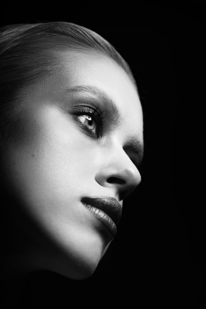 特写工作室的漂亮女人与花哨的化妆在黑色背景的肖像图片下载