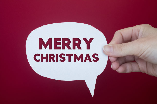 语音泡沫前面的彩色背景与圣诞快乐的文本。图片下载