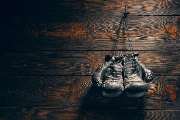 旧拳击手套挂在木墙的钉子上，留有文字复制空间图片下载
