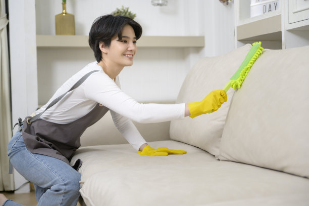 快乐的亚洲年轻女子扫地沙发和家具清洁房子，健康的生活理念图片下载